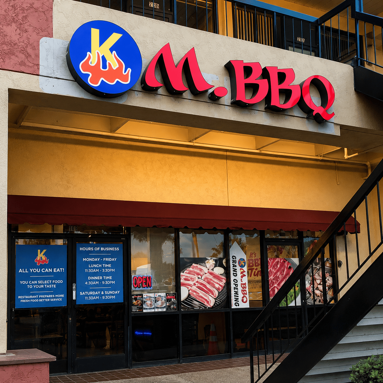 The KM.BBQ storefront: the sign above the entrance, the awning and the door
